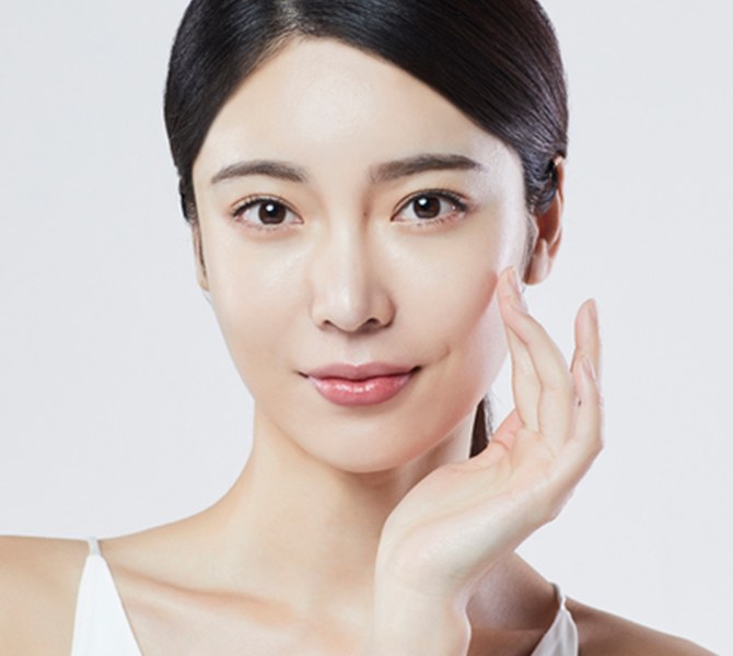 Woman touching her smooth cheek